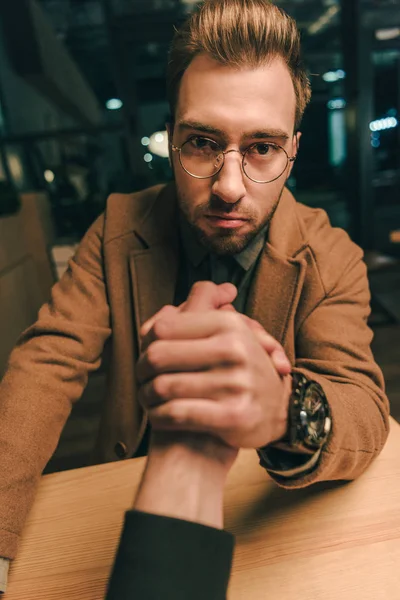 Camera point of view focused man arm wrestling with opponent in cafe — Stock Photo