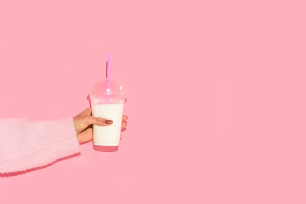 Partial view of african american woman holding glass of milk with straw against pink wall — Stock Photo