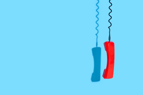 View of old telephone handset on blue background — Stock Photo