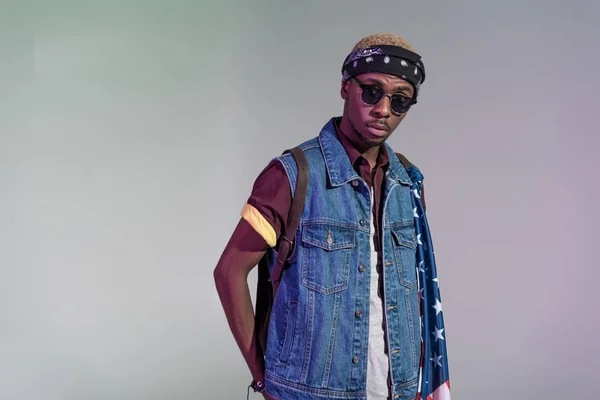 Portrait of stylish young african american man in sunglasses looking at camera isolated on grey — Stock Photo