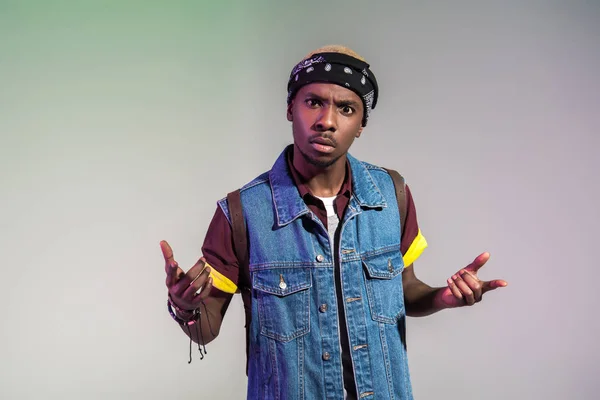 Aggressive young african american man gesturing with hands and looking at camera isolated on grey — Stock Photo