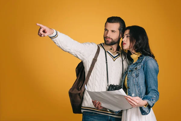Boyfriend pointing on something isolated on yellow — Stock Photo