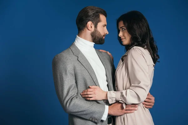 Attractive boyfriend and girlfriend hugging isolated on blue — Stock Photo