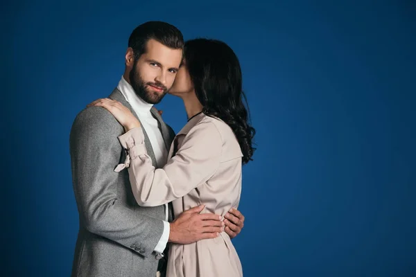 Attractive boyfriend and girlfriend hugging isolated on blue — Stock Photo