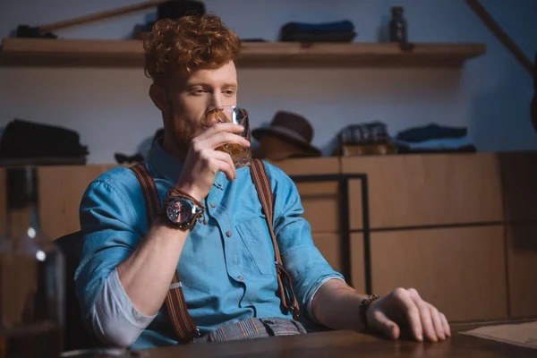 Stylish young redhead man drinking whiskey — Stock Photo