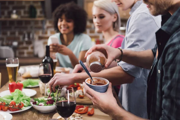 Abgeschnittenes Bild eines Mannes, der Sauce Würze verleiht — Stockfoto