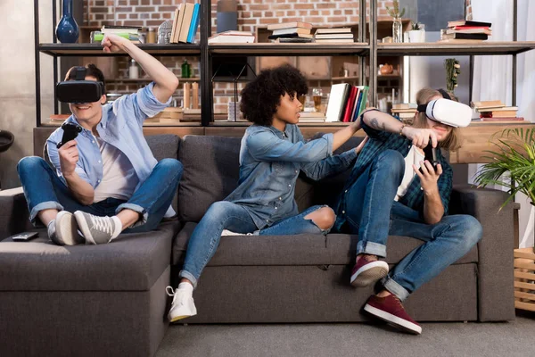 African american girl asking friends to play video game with virtual reality headsets — Stock Photo