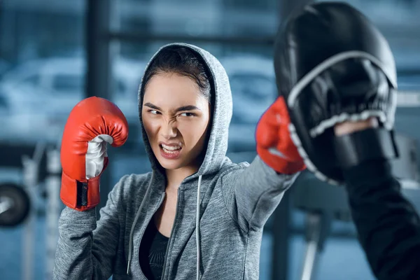 Aggressive junge Boxerin trainiert im Fitnessstudio — Stockfoto