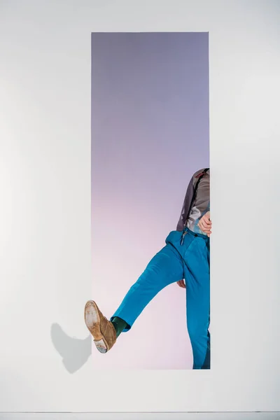 Cropped image of man in stylish clothes going through frame on white — Stock Photo