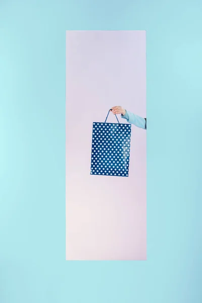 Cropped image of girl holding shopping bag in frame isolated on turquoise — Stock Photo