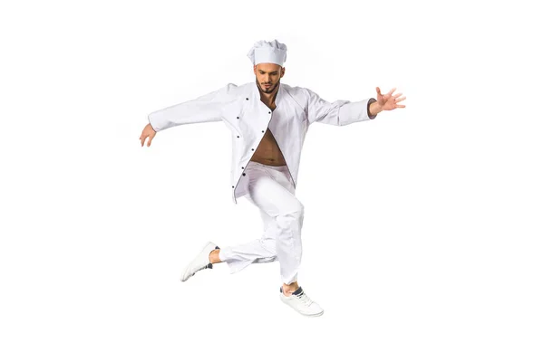 Jovem chef em uniforme pulando isolado no branco — Fotografia de Stock
