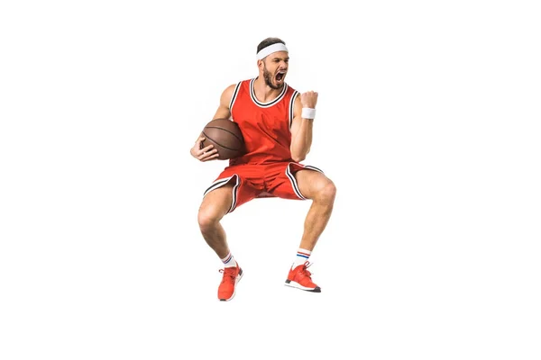 Triumphing young basketball player jumping with ball isolated on white — Stock Photo