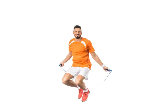 Young man jumping with skipping rope and smiling at camera isolated on white — Stock Photo