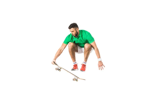 Handsome young man jumping with longboard isolated on white — Stock Photo