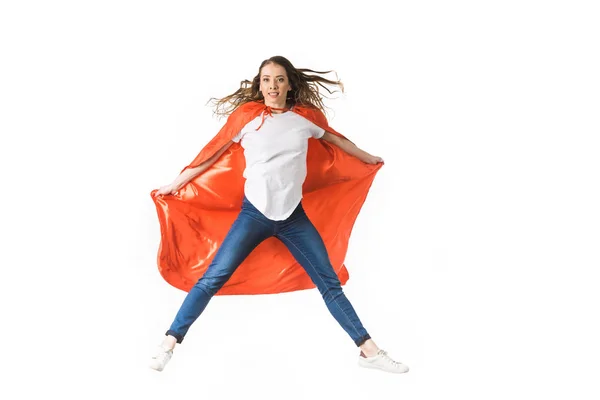 Young woman in red mantle jumping and looking at camera isolated on white — Stock Photo