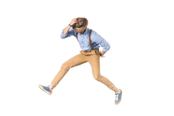 Stylish young man in hat jumping isolated on white — Stock Photo