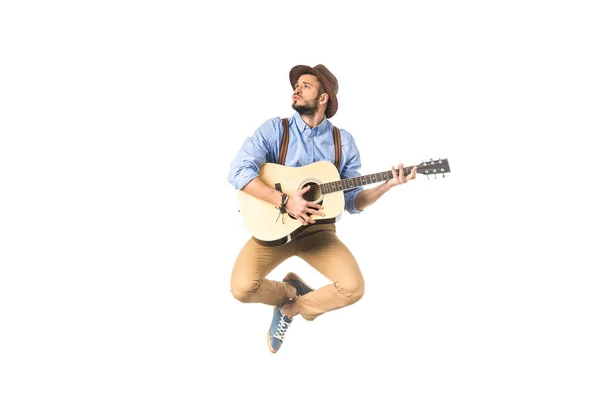 Romantic young musician looking away while playing guitar and jumping isolated on white — Stock Photo
