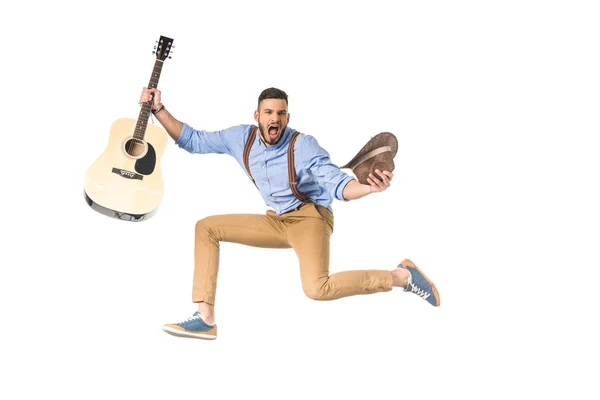 Excited young musician with guitar and hat screaming at camera isolated on white — Stock Photo