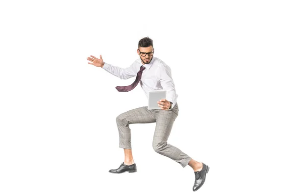 Young businessman using digital tablet and jumping isolated on white — Stock Photo