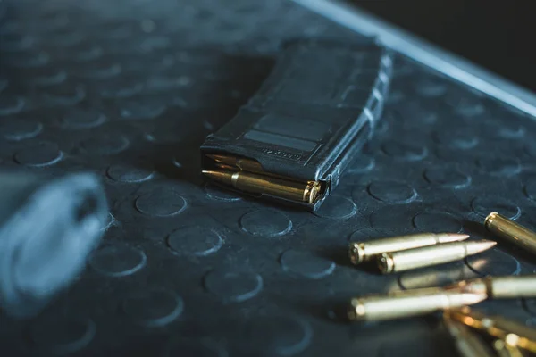 Close up view of bullets and rifle magazine on table — Stock Photo