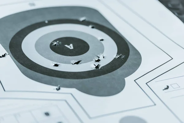 Used gun target with holes after bullets in shooting range — Stock Photo