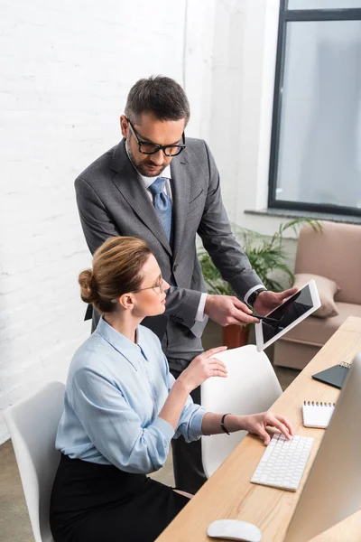 High angle view of businesspeople working together with tablet at office — Stock Photo