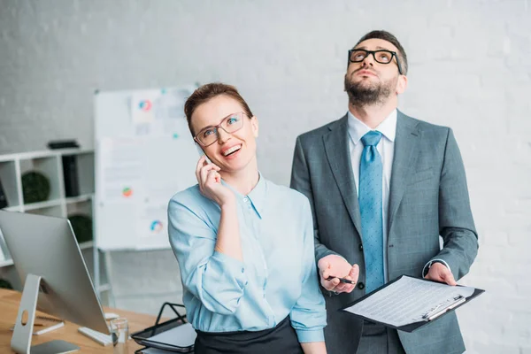Businessman asking his colleague to sign contract while she talking by phone and annoying him — Stock Photo
