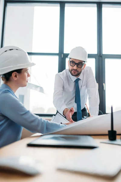 Architects working with building plan at modern office — Stock Photo