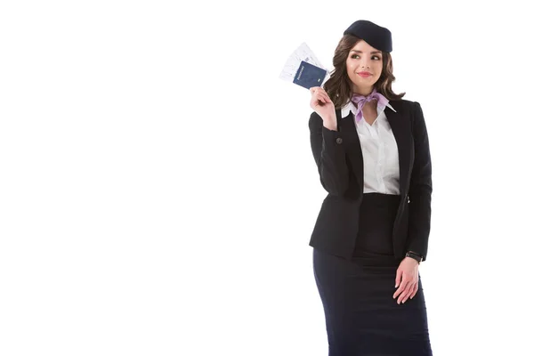 Beautiful stewardess showing passport and tickets isolated on white — Stock Photo