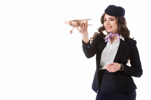 Schöne Stewardess spielt mit Flugzeugmodell isoliert auf weiß — Stockfoto
