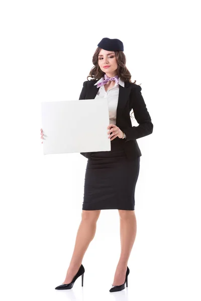 Attractive stewardess holding empty board isolated on white — Stock Photo