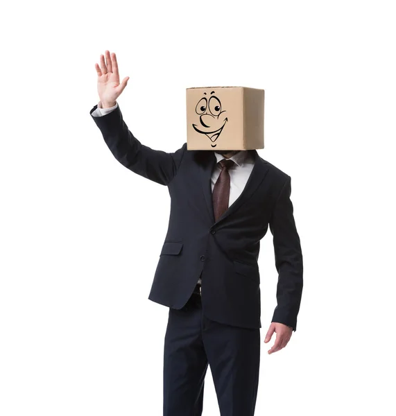 Businessman with cardboard box on head and happy face on it waving hand isolated on white — Stock Photo