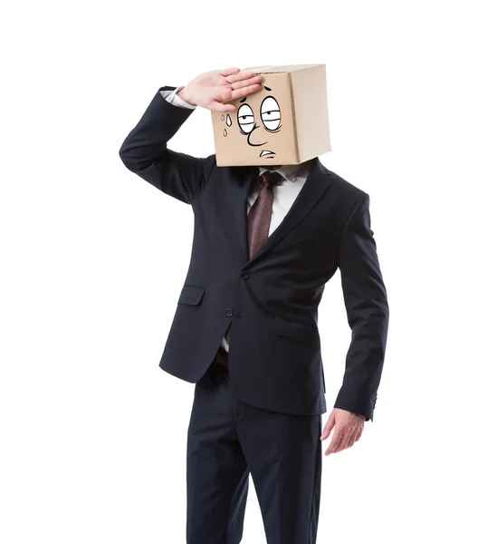 Tired businessman with cardboard box on head wiping sweat isolated on white — Stock Photo