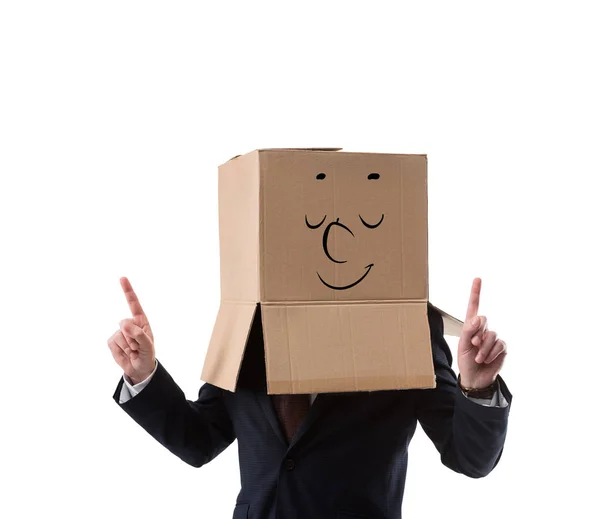 Relaxed businessman with cardboard box on head pointing up with fingers  isolated on white — Stock Photo