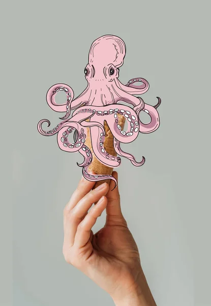 Cropped image of woman holding waffle ice cream cone with octopus isolated on gray — Stock Photo