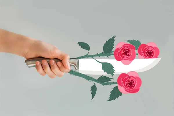 Cropped image of woman holding knife with roses isolated on gray — Stock Photo