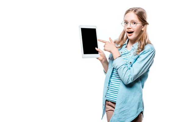 Surprised girl in eyeglasses pointing with finger at digital tablet with blank screen isolated on white — Stock Photo