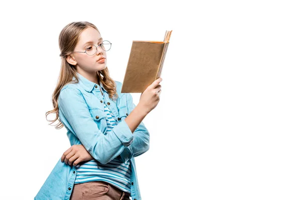 Beautiful teenage girl in eyeglasses reading book isolated on white — Stock Photo