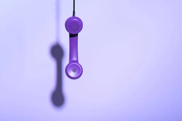 Hanging purple telephone handset, ultra violet trend — Stock Photo