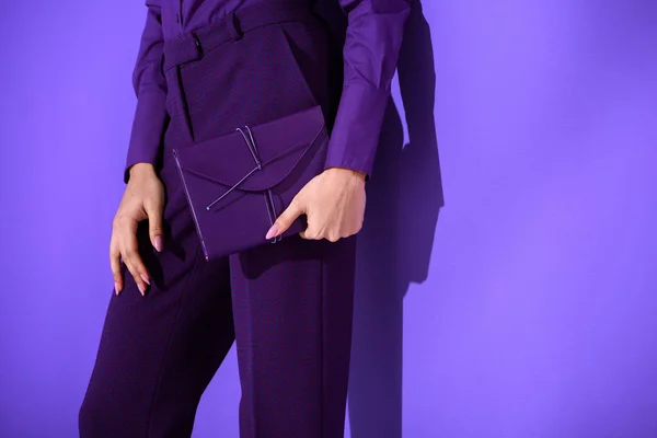 Cropped view of girl in purple suit holding purple diary, ultra violet trend of 2018 year — Stock Photo