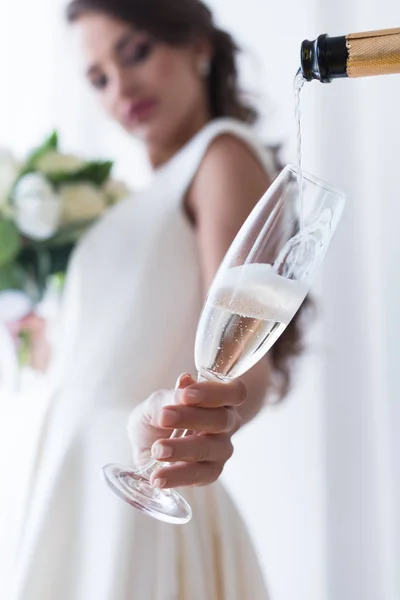 Selective focus of bride holding glass of champagne — Stock Photo