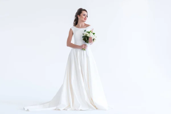 Hermosa novia morena posando en vestido blanco con ramo de bodas, aislado en blanco - foto de stock