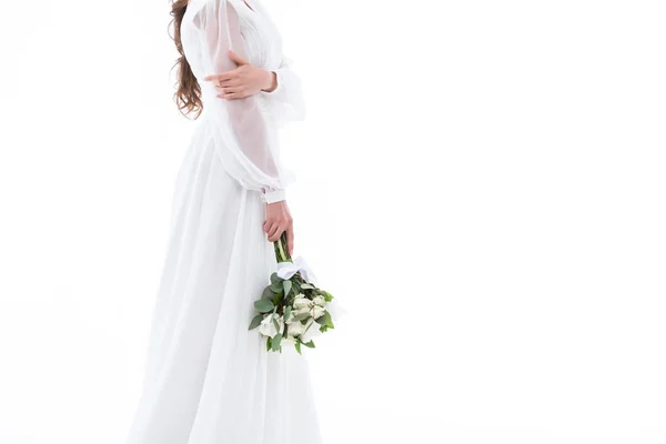 Cropped view of bride in traditional dress with wedding bouquet, isolated on white — Stock Photo