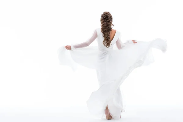 Vista trasera de la novia elegante bailando en vestido de novia tradicional, aislado en blanco - foto de stock