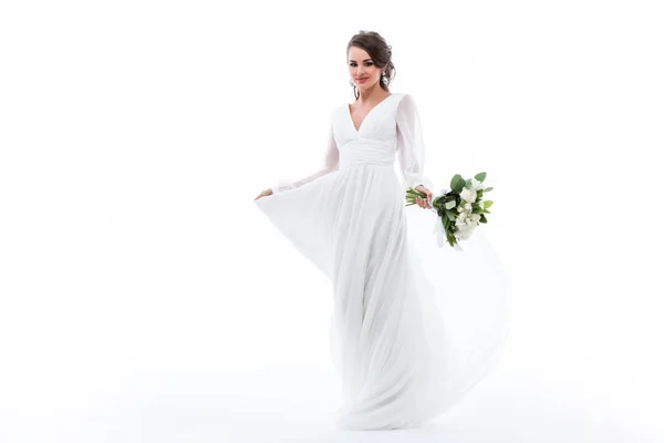 Attractive bride posing in white dress with wedding bouquet, isolated on white — Stock Photo