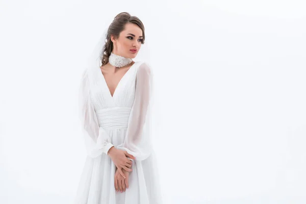 Elegant brunette bride posing in traditional wedding dress, isolated on white — Stock Photo