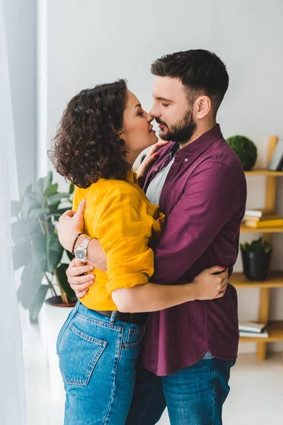 Side view of young couple holding each other — Stock Photo