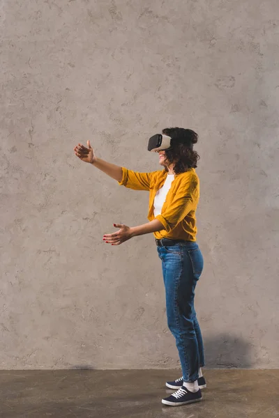 Вид збоку молодої жінки з використанням гарнітури віртуальної реальності — стокове фото