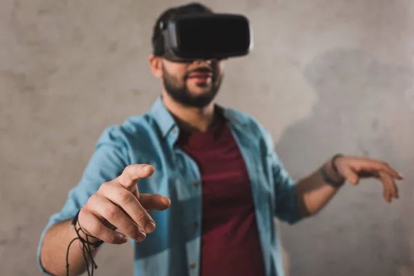 Homem sorridente usando fone de ouvido de realidade virtual — Fotografia de Stock