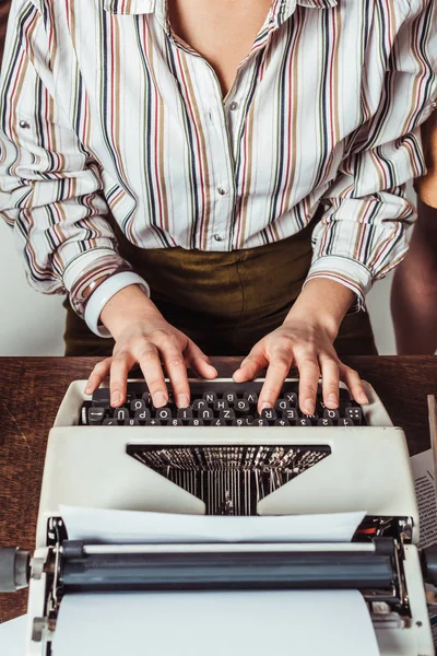 Cropped image of retro styled african american journalist typing at typewriter — Stock Photo